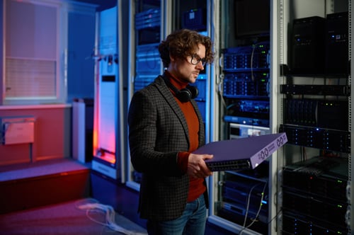 portrait-of-it-specialist-holding-hardware-in-hand-2024-12-04-01-54-33-utc