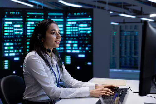 smiling-engineer-in-data-center-providing-support-2024-10-16-17-24-08-utc