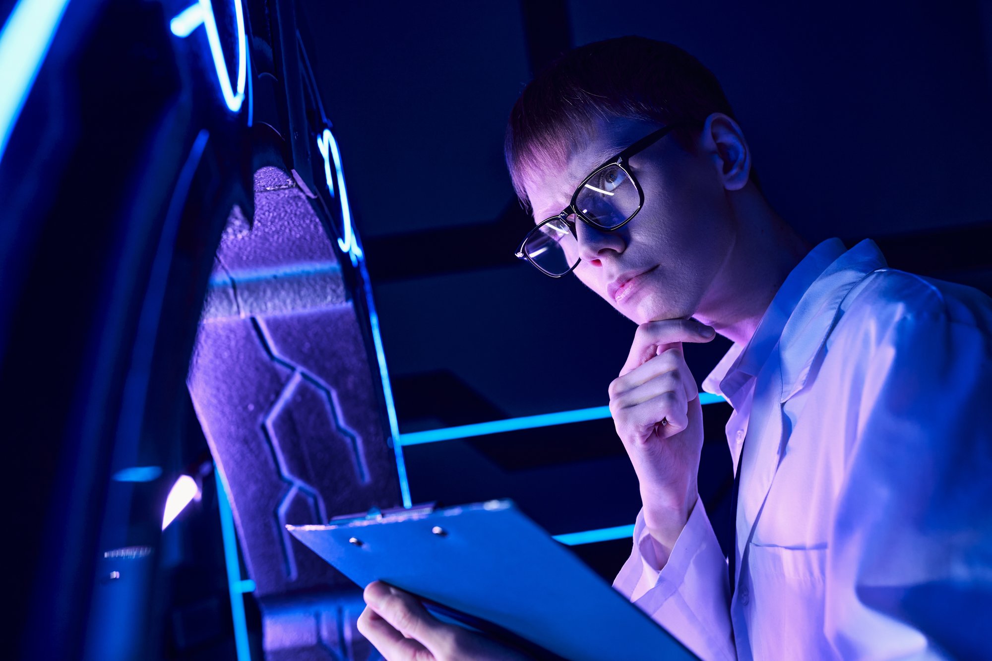 young-thoughtful-scientist-with-clipboard-in-neon-2024-11-08-13-01-35-utc